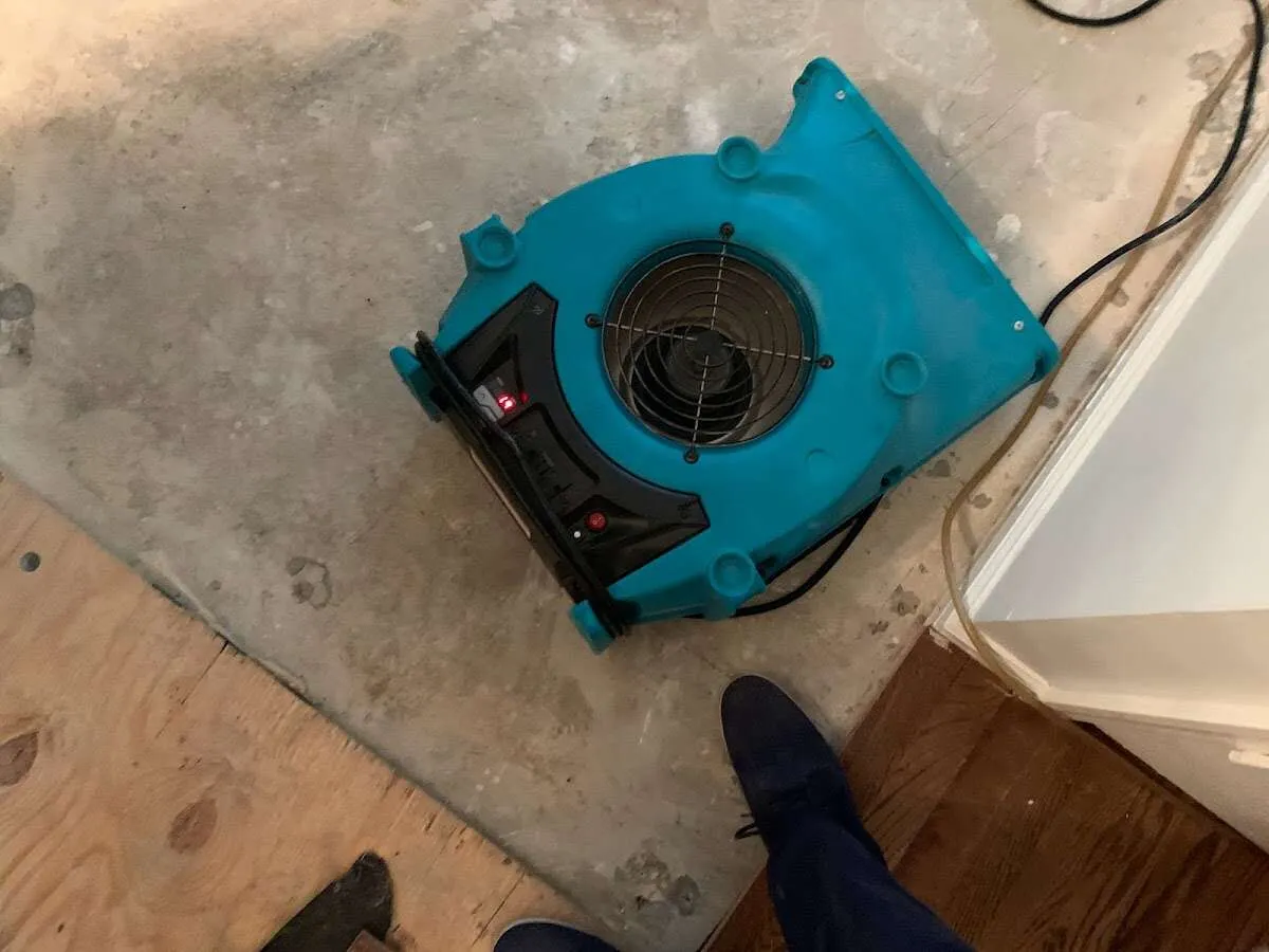 Air mover drying subfloor during Leak Detection & Repair in Fitchburg